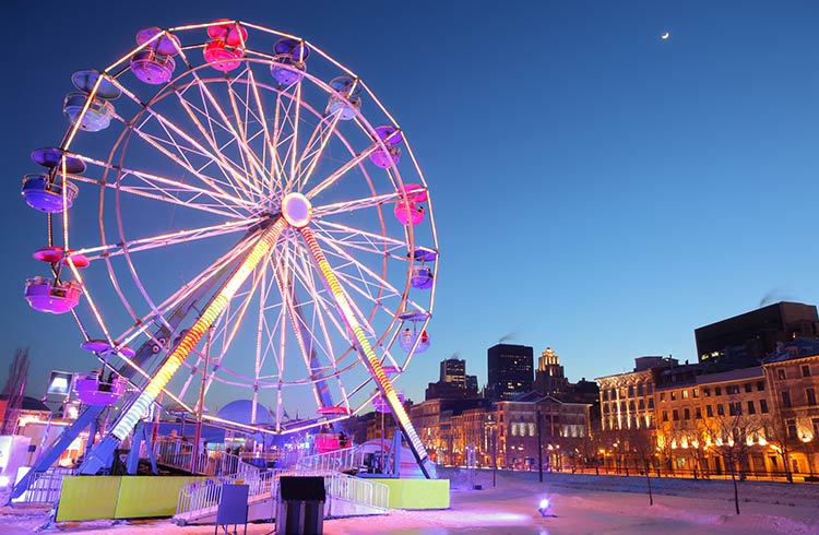 A ferris wheel lit up at night in Old Montreal, Quebec