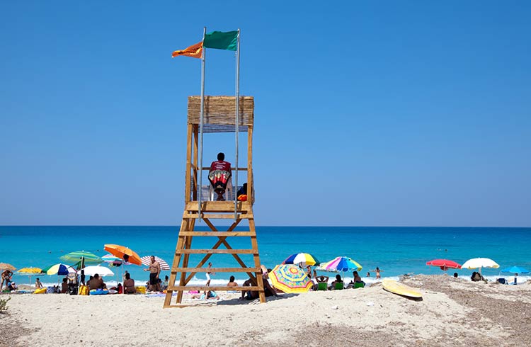 People swim and sunbath at Agios Yiannis (Ai Yiannis) beach