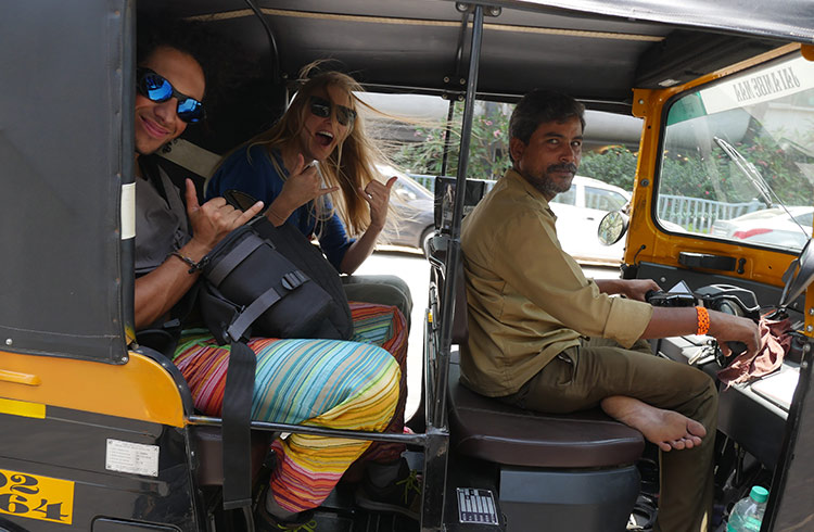 Two travelers in a tuk-tuk in India