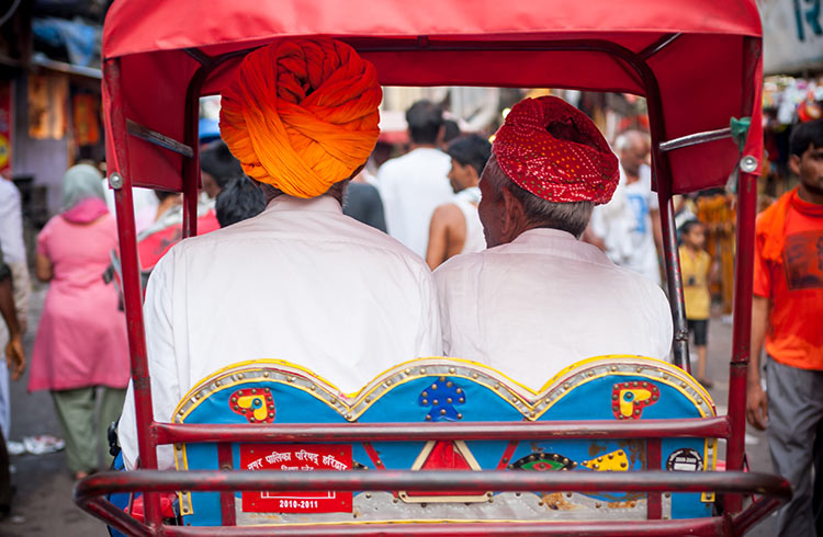 Two men riding in a rickshaw in Haridwar, India.