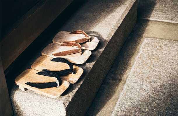 Wooden sandals lined up next to a doorway in Japan.