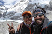 Two hikers posing near Mt. Everest