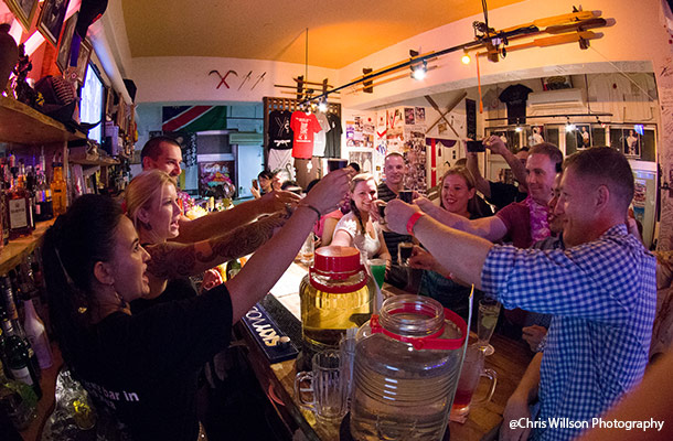 Customers raise glasses at Dojo Bar in Naha City, Okinawa.