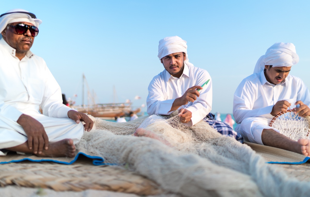 Men from the Gulf Cooperation Council (GCC) demonstrate the traditional tools of their maritime heritage on the beaches of Qatar. Their headdresses indicate the country they're from.