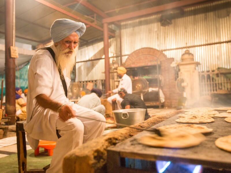 This man's job is cooking the roti in an already toasty room made even warmer by this huge cooking surface. Doesn't he look cool doing it, though?