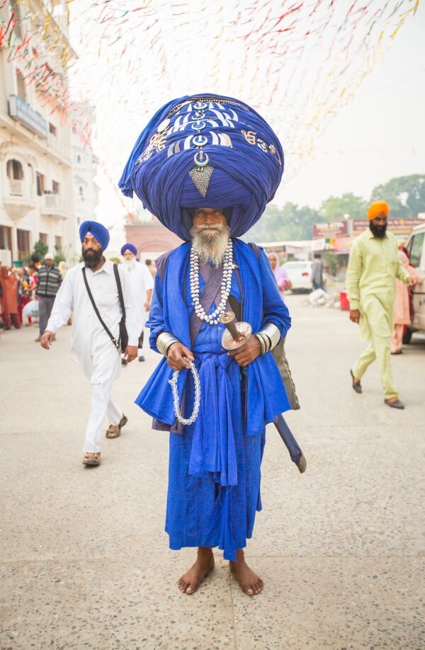 This Sikh man is well known and appears in many photos, and you can see why. In addition to his uncut beard and huge turban that houses his hair, he is carrying the symbolic items of a Sikh: Kangha (wooden comb for hair), Kara ( an iron bracelet), Kachera (cotton undergarment), and finally a Kirpan, a sword or dagger large enough to defend oneself.  