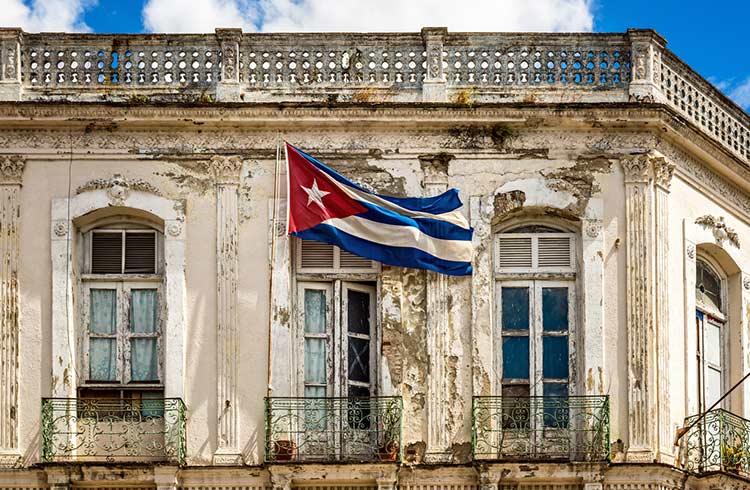 The Cuban flag against a dilapidated building