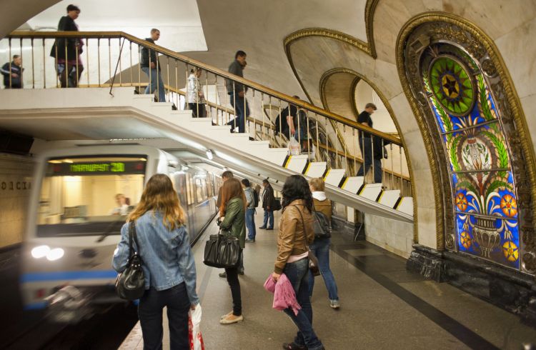 People walking downstairs for the station in lower floor and others are waiting for the train in Moscow Metro