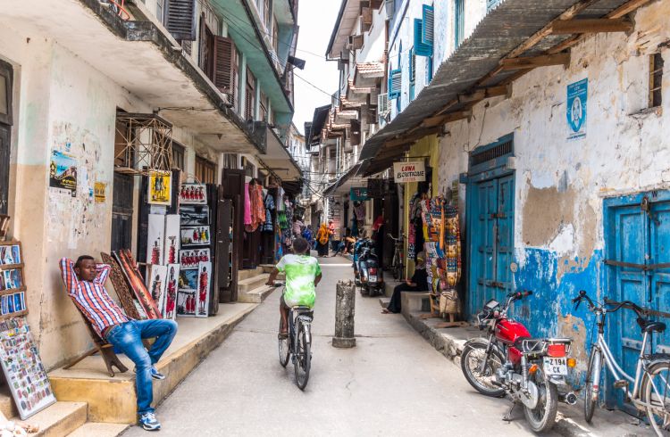 View on typical narrow Stone Town street with souvenir shops on Zanzibar island
