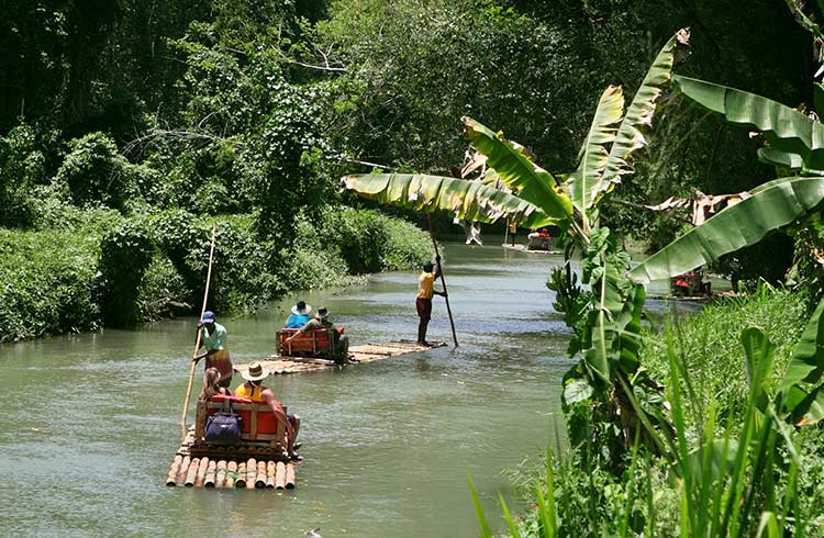 Travelers on bamboo rafts at Martha Brae River