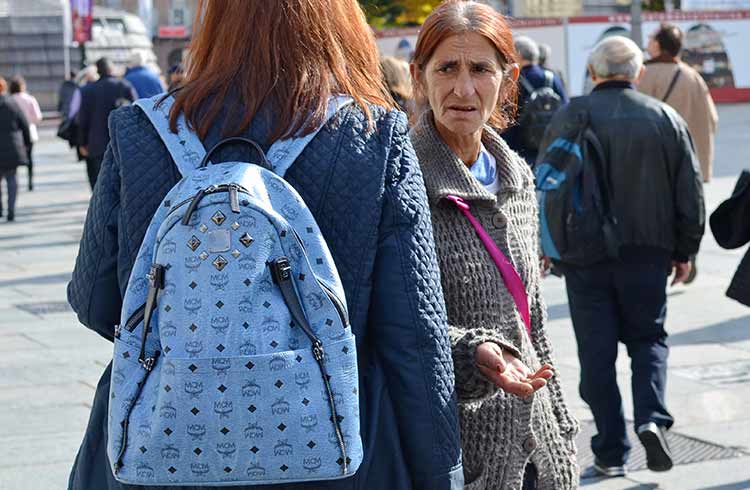 Elderly woman begging for money at Torino, Italy