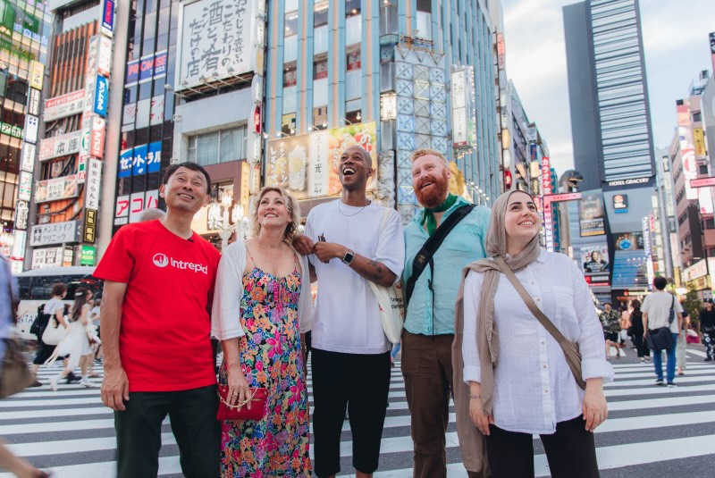 A tour group and their guide in a busy Japanese city