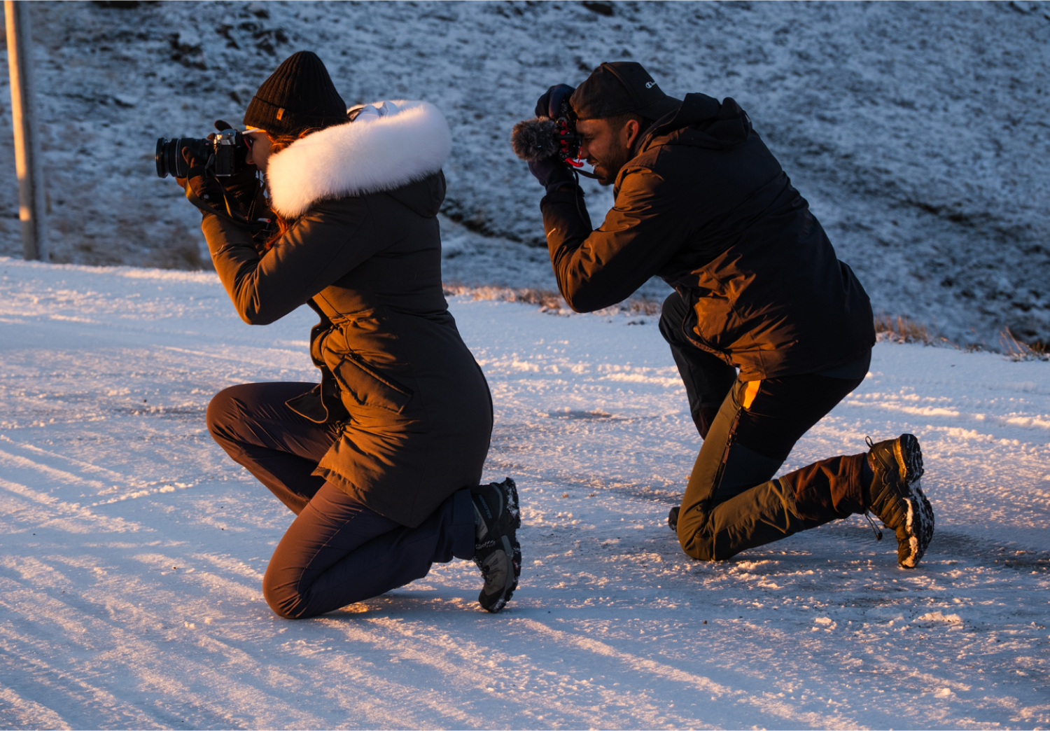 Two photographers kneeling to take a photo