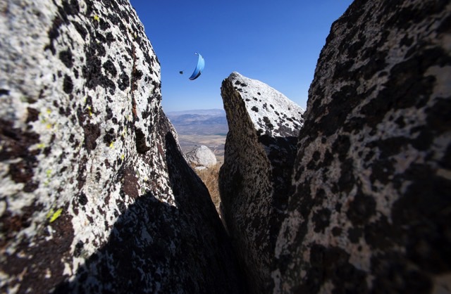 a paraglider photographed between 2 rocks