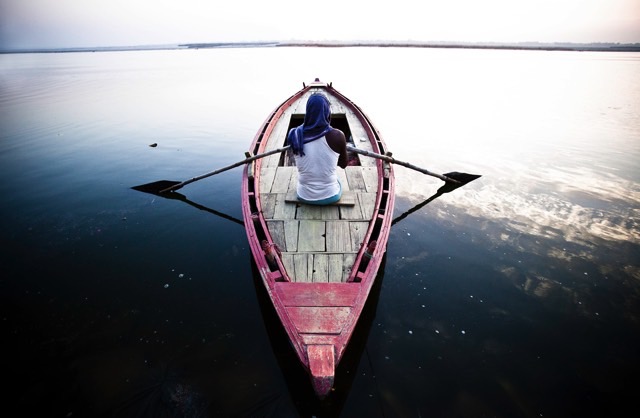 a ferryman rows his boat