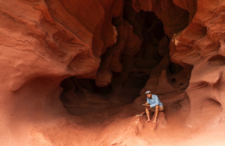 A traveler in a sandstone cave
