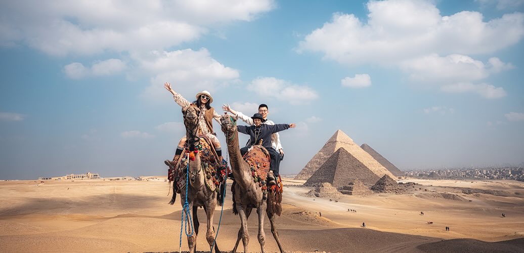 Camel riding in front of the Pyramids