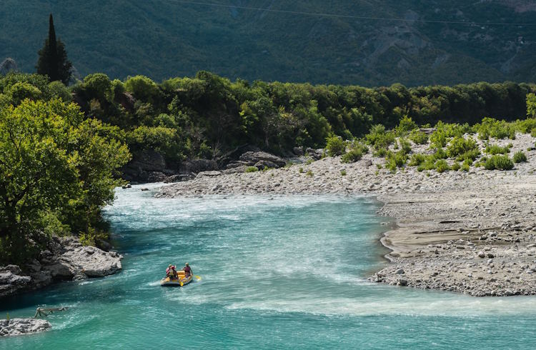 A group of people rafting on the Vjosa River in Albania.