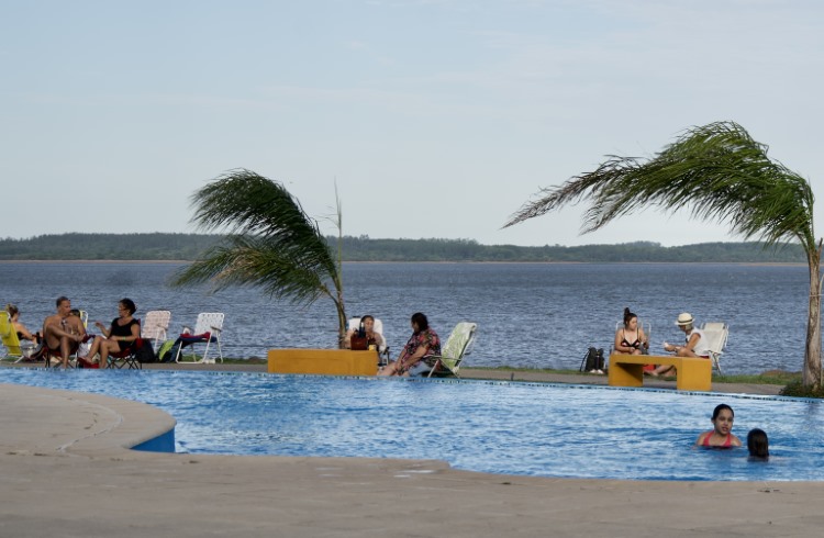 People relax at Punta Viracho hot spring on the banks of Salto Grande, Entre Rios, Argentina.
