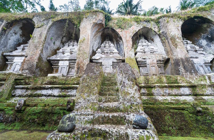 Ancient shrines carved into a rock cliff at Pura Gunung Kawi near Ubud, Bali.