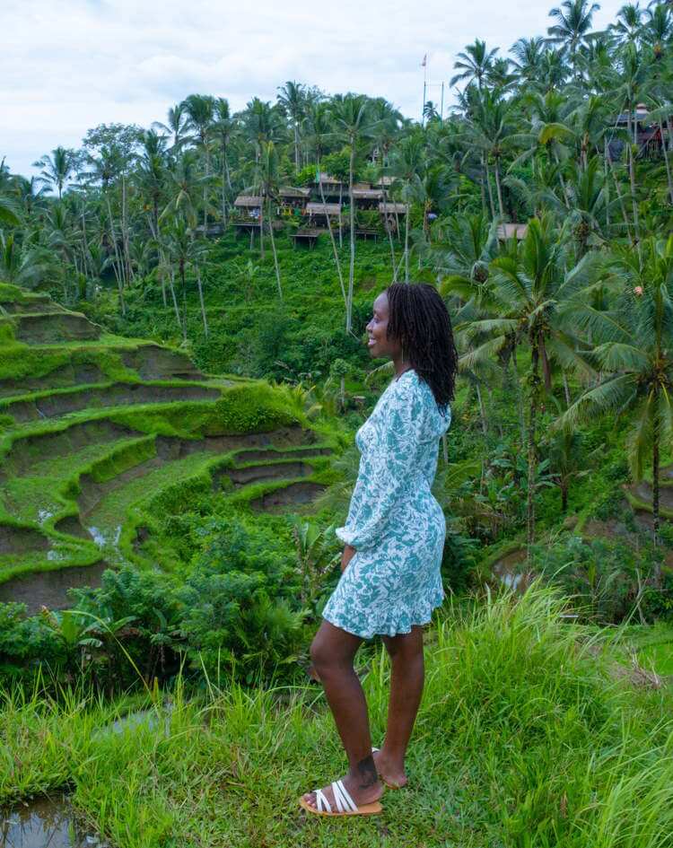 A woman overlooks terraced hills on the Campuhan Ridge Walk near Ubud, Bali.