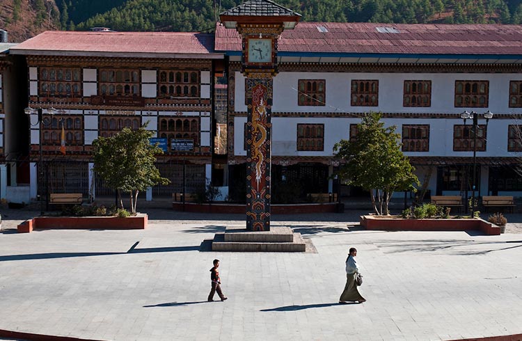 Visitors walk around a dzong in Bhutan.