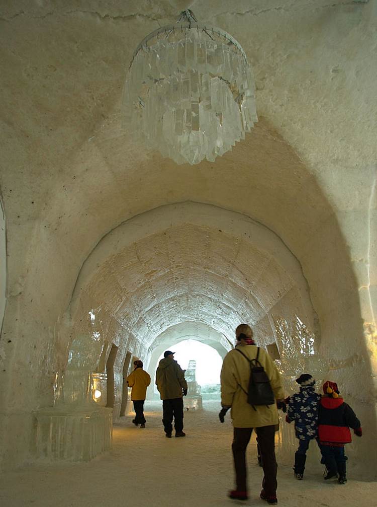 Visitors walk under an ice candalabra at the Ice Hotel Quebec.