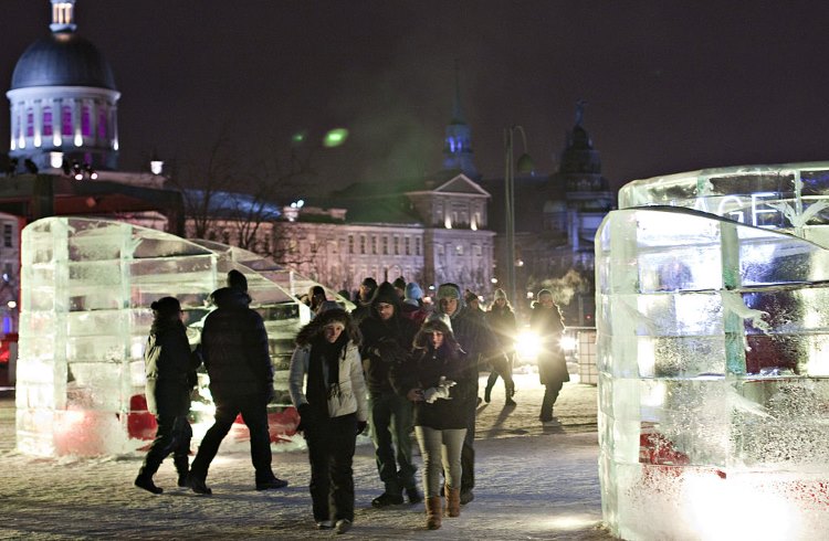 Guests walk past glowing igloos at Igloofest, Montreal, Canada.