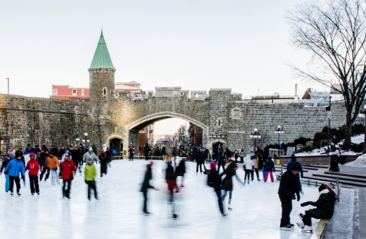 Ice skaters at the Place D’Youville skating rink just outside the ramparts of Old Quebec, Canada.