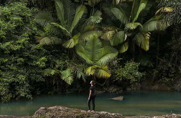 A woman standing at the edge of a lake in Puerto Rico.