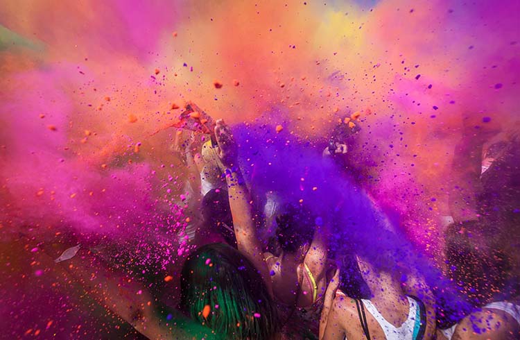 Colorful powder is thrown at the Holi festival in Trinidad.