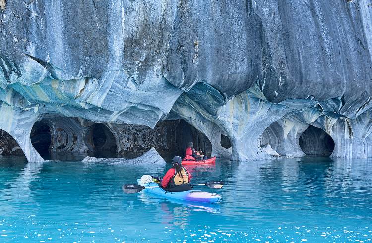 Kayakers explore the wind-sculpted Marble Chapels in Lake General Carrera, southern Chile.
