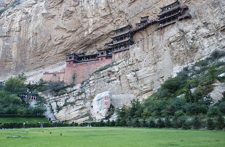 The incredible dragon-shaped Hanging Monastery sitting on the side of a cliff