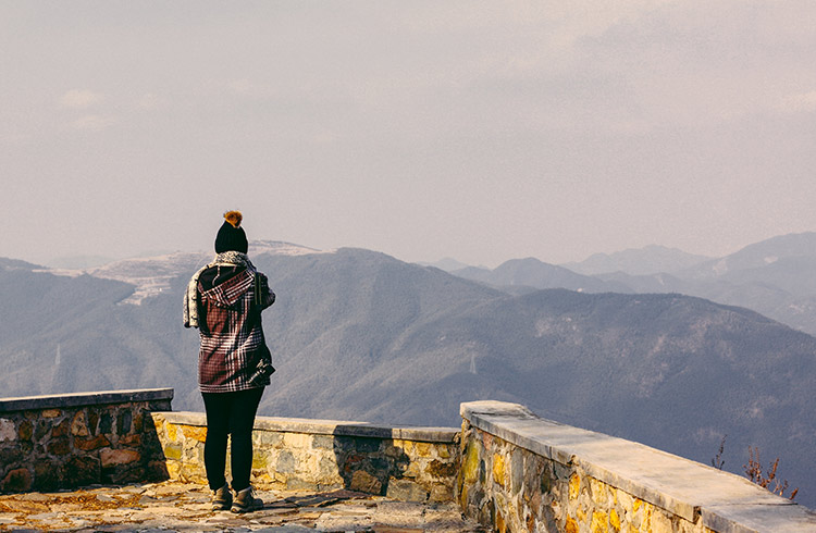 A woman stands at a lookout on Moganshan mountain