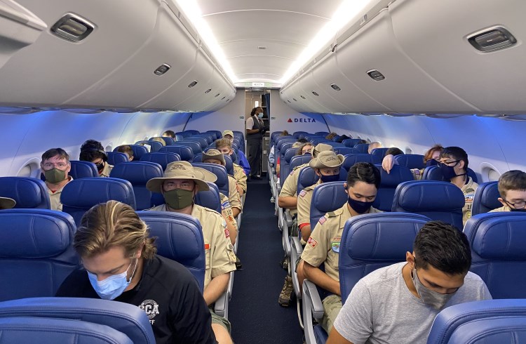 Masked passengers on a Delta flight during the COVID-19 pandemic.