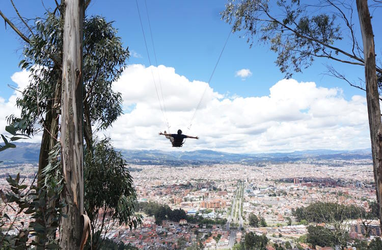 A visitor on a high swing overlooking the city of Cuenca, Ecuador.