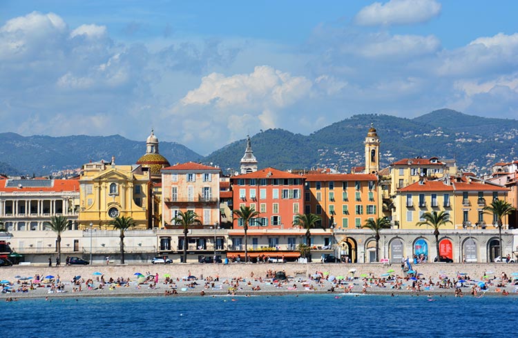 View of the Promenade des Anglais, the mountains , the beach and its beautiful buildings in Nice