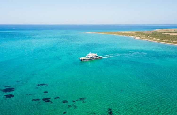 A passenger ferry sails between the Peloponnese Islands of Greece.