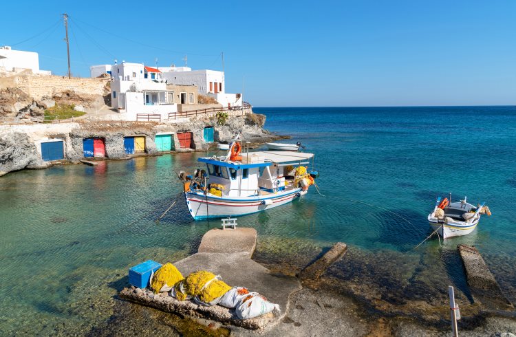Colorful boats in the harbor of a small fishing village on the Greek island of Kimolos.