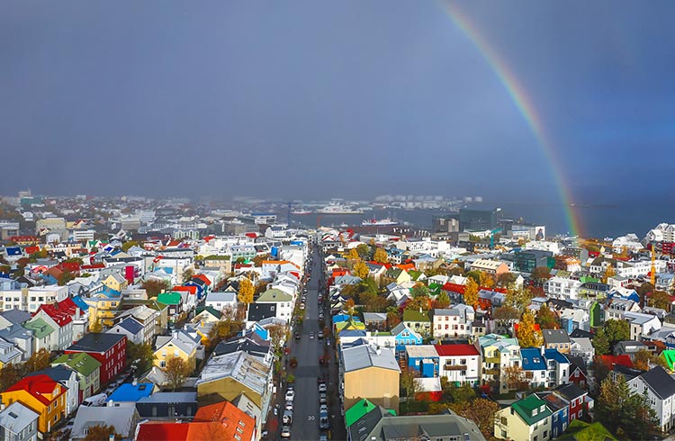 Aerial view over downtown Reykjavik from the top of Hallgrimskirkja church with rainbow and ocean, capital city of Iceland