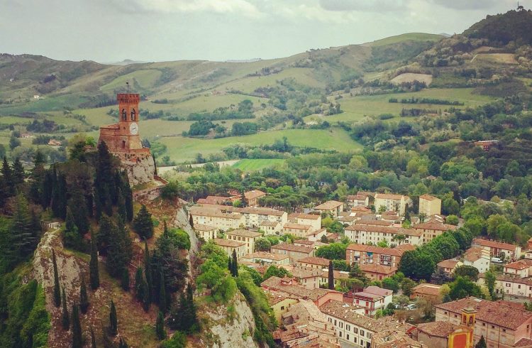 A medieval clock tower on a hilltop overlooking the village of Brisighella, Italy. 