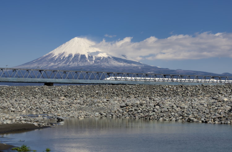 A bullet train passes in front of Mt. Fuji in Japan.