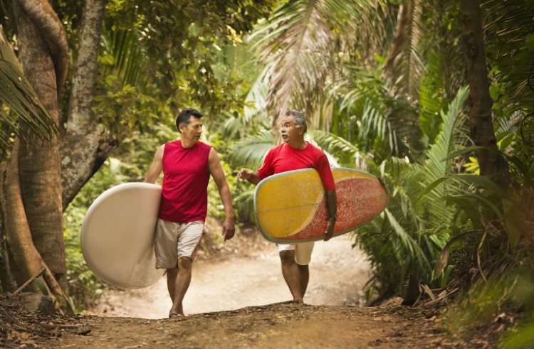 A pair of surfers walk on a jungle path near San Pancho, Nayarit, Mexico.