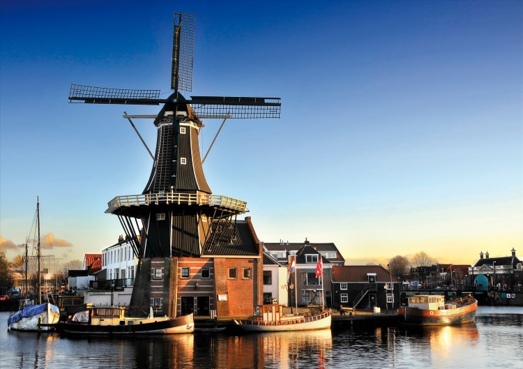 The iconic Adriaan Windmill on the riverfront in Haarlem, the Netherlands.