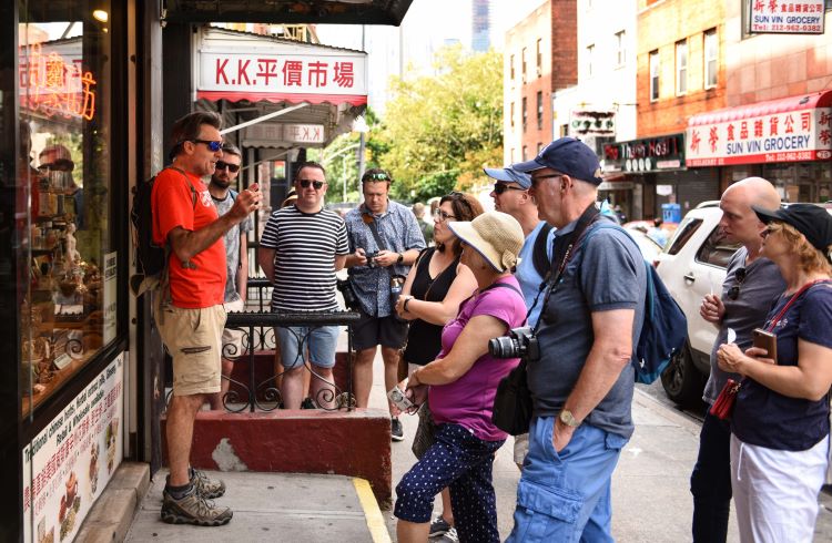 Visitors on a walking tour of the authentic Chinatown of New York's Lower East Side.