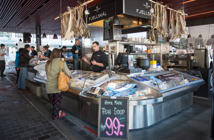 A customer stands at the fish market counter in Bergen, Norway