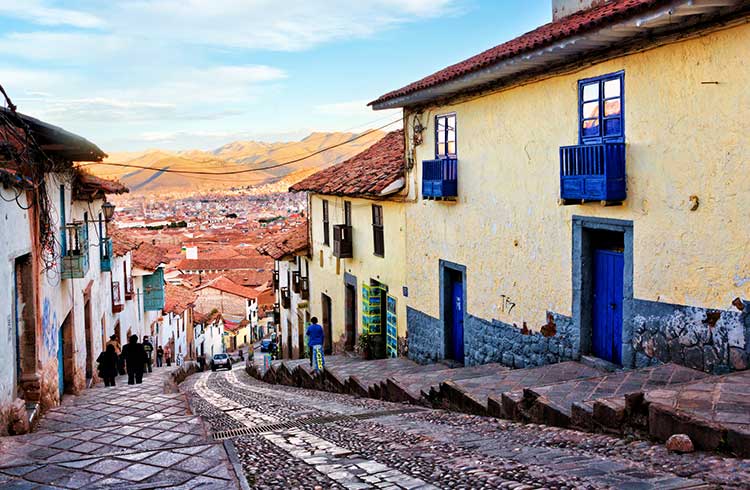 Historic architecture of Cusco along steep street northwest of Plaza de Armas, Peru