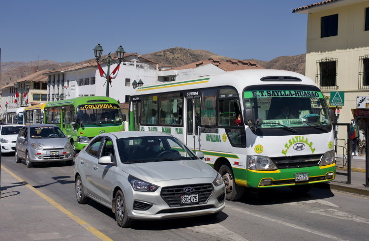 Local cars and buses on the streets of Cusco, Peru. 