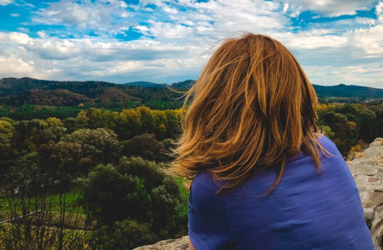 A woman gazes at the mountainous landscape around Sanok, Poland.
