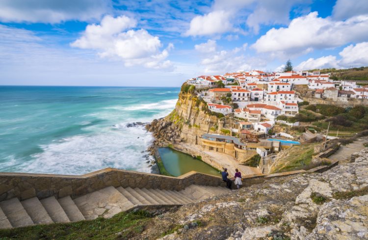 Whitewashed buildings on a cliff above the sea in Azenhas do Mar, near Lisbon, Portugal.